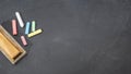 Group of colored chalk sticks and eraser on blackboard Royalty Free Stock Photo