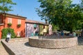 Group of colored houses in the old square with masonry basins originally used for the conservation of freshly caught fish.