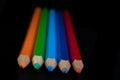 GROUP OF COLORED PENCILS ALIGNED ON BLACK BLACKGROUND Royalty Free Stock Photo