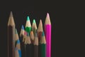 GROUP OF COLORED PENCILS ALIGNED ON BLACK BLACKGROUND Royalty Free Stock Photo