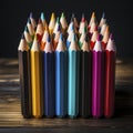 A group of colored pencils arranged upright on a wooden surface Royalty Free Stock Photo