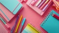 Group of Colored Pencils and Notebook on Pink Background Royalty Free Stock Photo