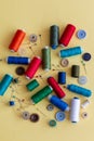 A group of colored sewing things on a yellow background