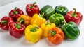 A group of colorful bell peppers arranged on a white surface Royalty Free Stock Photo