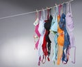 Numerous Colorful Bras Are Hung On A Close Line In A Studio Environment