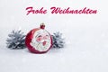 Group of colorful Christmas ball with drawing of Santa Claus and pines with text in German `Frohe Weihnachten` Royalty Free Stock Photo