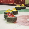 Group of curling rocks on ice close-up Royalty Free Stock Photo