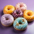 a group of colorful donuts on a purple surface