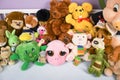 Group of colorful fluffy stuffed animal toys close up in a white wooden baby crib Royalty Free Stock Photo