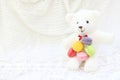Group of colorful fresh sweet cake macarons pile with white bear doll on white fabric background, have copy space