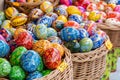 Group of colorful handmade Easter eggs in a few baskets, set of handcrafted traditional Polish pisanki, group of objects, detail