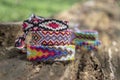 Group of colorful handmade homemade natural woven bracelets of friendship on old wood background, checkered patterns Royalty Free Stock Photo