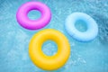 Group of colorful inflatable tubes floating in a swimming pool