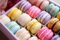 a group of colorful macarons neatly aligned in a decorative box