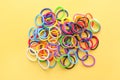 Group of Colorful mini rubber bands soft elastic bands for hair on yellow background. elastic hair ties Royalty Free Stock Photo