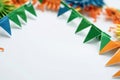 A group of colorful paper bunting on a white surface, great for decoration or illustration