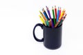 Group of colorful pencils in the black cup isolated on the white background Royalty Free Stock Photo