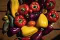 Group of colorful peppers, tomatoes and cucumbers on wooden background Royalty Free Stock Photo