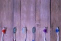 Colorful toothbrushes on a wooden background. Royalty Free Stock Photo