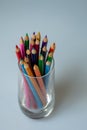 A group of coloured pencils in a glass tumbler Royalty Free Stock Photo