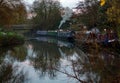 A group of colourful canal boats moored at the Maltings mooring on the River Stort