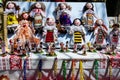 Group of colourful textile traditional hand made decorations, dolls and toys for children, available for sale at a traditional Royalty Free Stock Photo