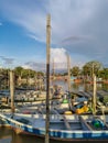 Group of colourful wooden traditional fishing boats parked on old pier fishing village, reflection of fishing boats, mangrove fore Royalty Free Stock Photo