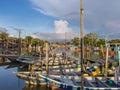 Group of colourful wooden traditional fishing boats parked on old pier fishing village, reflection of fishing boats, mangrove fore Royalty Free Stock Photo