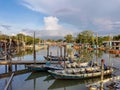 Group of colourful wooden traditional fishing boats parked on old pier fishing village, reflection of fishing boats, mangrove fore Royalty Free Stock Photo