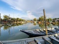 Group of colourful wooden traditional fishing boats parked on old pier fishing village, reflection of fishing boats, mangrove fore Royalty Free Stock Photo