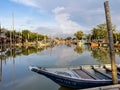 Group of colourful wooden traditional fishing boats parked on old pier fishing village, reflection of fishing boats, mangrove fore Royalty Free Stock Photo