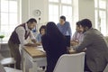 Team manager or business coach teaching young people during a meeting in the office Royalty Free Stock Photo