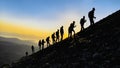 Group of compatible friends climbers hiking to the summit at sunrise Royalty Free Stock Photo