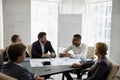 Group of concentrated happy multiracial business people discussing strategy. Royalty Free Stock Photo