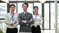 Group of confident Asian businesspeople standing with their arms crossed. Team building Royalty Free Stock Photo