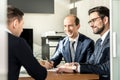 Group of confident successful business people reviewing and signing a contract to seal the deal at business meeting in Royalty Free Stock Photo