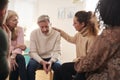 Group Consoling Man Speaking At Support Group Meeting For Mental Health Or Dependency Issues Royalty Free Stock Photo