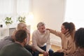 Group Consoling Man Speaking At Support Group Meeting For Mental Health Or Dependency Issues Royalty Free Stock Photo