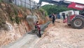 Group of construction workers pouring wet concrete using the mobile crane bucket the construction site. Royalty Free Stock Photo