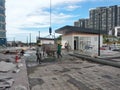 Group of construction workers pouring wet concrete using the mobile crane bucket the construction site. Royalty Free Stock Photo