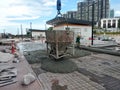 Group of construction workers pouring wet concrete using the mobile crane bucket the construction site. Royalty Free Stock Photo