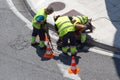 Group of construction Workers repairing an asphalt road on city Royalty Free Stock Photo