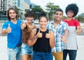 Group of cool african american and hispanic young adults showing thumb Royalty Free Stock Photo