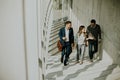 Group of corporate business professionals climbing at stairs in office corridor Royalty Free Stock Photo