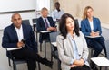 Group of corporate employees listening to business training