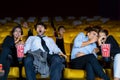 Group of couple people watching movie feeling scary and frightening at movie theater seats. The faces have feeling bad during film Royalty Free Stock Photo