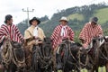 Group of cowboys wearing traditional ponchos