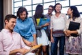 Group of coworkers holding folders and interactng Royalty Free Stock Photo