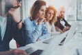 Group of coworkers working together on new business presentation at sunny meeting room.Horizontal.Blurred background. Royalty Free Stock Photo