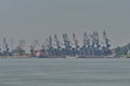 Group of cranes in the Braila port with the bridge over the Danube in the background. Royalty Free Stock Photo
